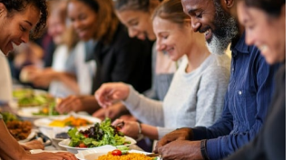Diverse group enjoying catered meals together