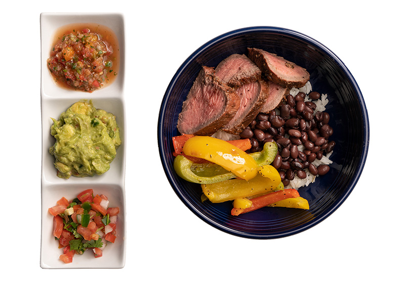 Steak with bell pepper, beans, and rice and guacamole, pico de gallo, and salsa side sauces