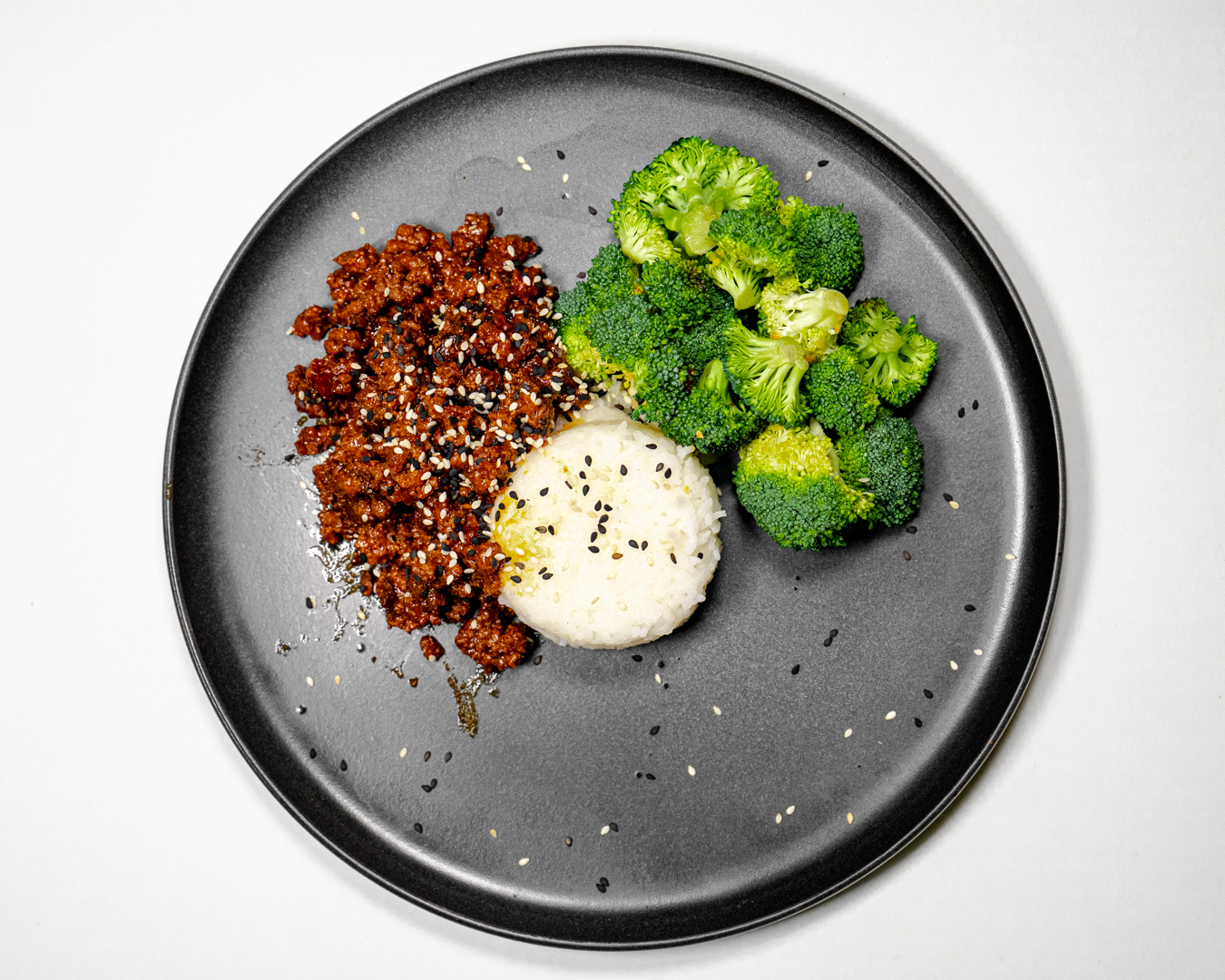 Korean BBQ Beef, Jasmine Rice & Broccoli on a black contemporary plate